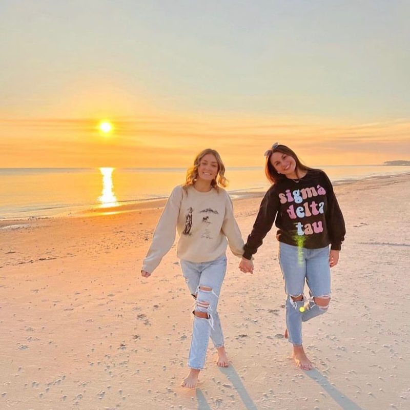 SDT members walking on a beach at sunset