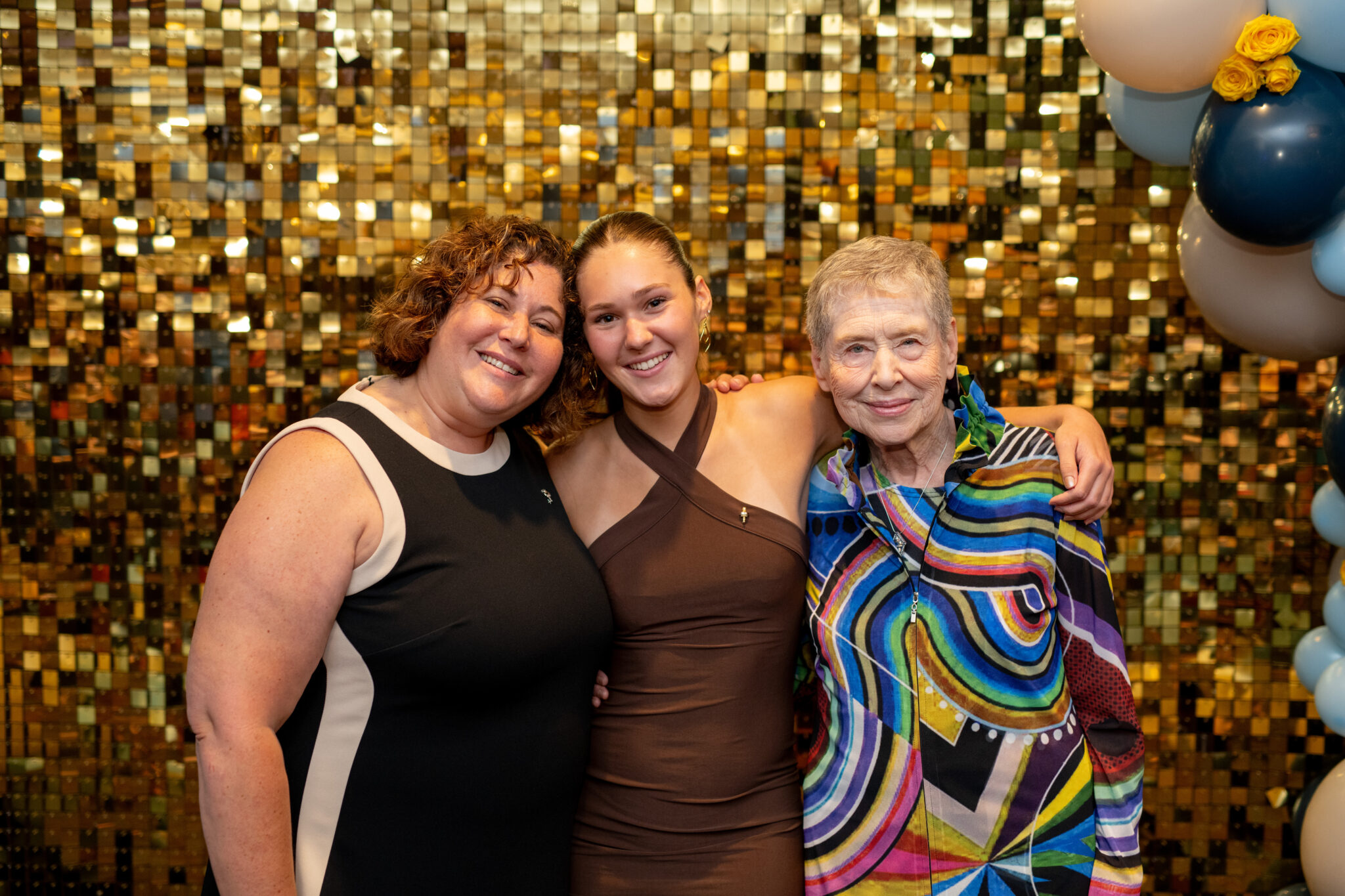 Three generations of women smile together 