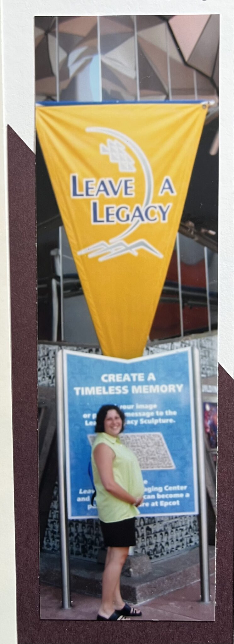 Pregnant woman poses with a sign about legacy.