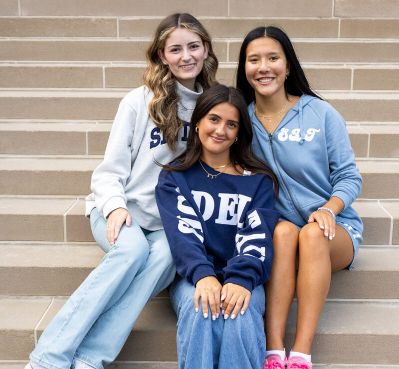 three girls sitting on stairs